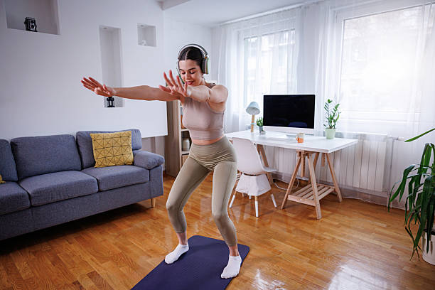Person doing a bodyweight squat in a bright living room